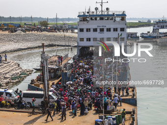 Crowds of people gather on ferry as they travel back home ahead of the Muslim festival Eid al-Fitr at Shimulia ferry ghat in Munshiganj on M...