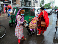 Relative transports a Covid-19 patient on the street outside of Dhaka Medical College Hospital for admission to get treatment during the cor...