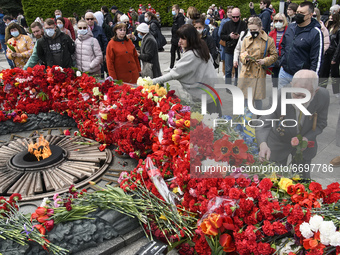 People carries flowers at the Tomb of the Unknown Soldier as they marks the Victory Day, the 76th anniversary of the victory over Nazi Germa...