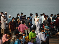 People wait to board  a ferry to their hometowns to celebrate Eid al-Fitr festivities amid Covid-19 coronavirus pandemic in Munshiganj near...