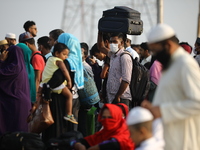 Apassenger react to the camera as People wait to board a ferry to their hometowns to celebrate Eid al-Fitr festivities amid Covid-19 coronav...