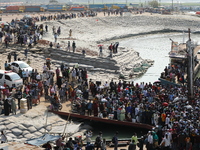 People crowd as they board a ferry to their hometowns to celebrate the Eid al-Fitr festivities amid Covid-19 coronavirus pandemic in Munshig...