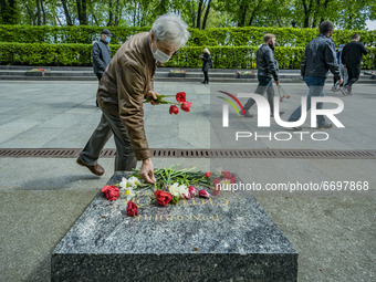 A man lays flowers in a memorial during the remembrance of the Victory Day of the Second World War on  9th of May in the Tomb of the Unknown...