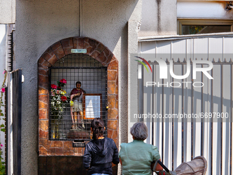 People offer prayers at a small shrine to Saint Expeditus outside a church in Santiago, Chile. (