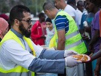 A member Assosiacion du Fraternitè Du Savoir help a migrant in Ventimiglia, on the French-Italian border, on June 23, 2015. The situation of...