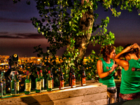 Bartenders set up a bar with music and dancing for an exclusive night party taking place at the base of the 14m-high statue of the Virgen de...