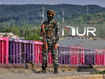 A Central Reserve Police Force (CRPF Cop) is seen at a temporary check point during COVID-19 Corona Curfew in Baramulla, Jammu and Kashmir,...