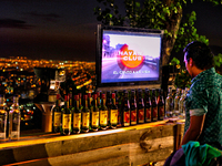 Bartender sets up a bar with music and dancing for an exclusive night party taking place at the base of the 14m-high statue of the Virgen de...