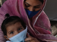 A Mother adjust Surgical face mask on her child at a  Health Camp amid Covid-19 pandemic on Mothers Day in Kolkata on May 09,2021. (