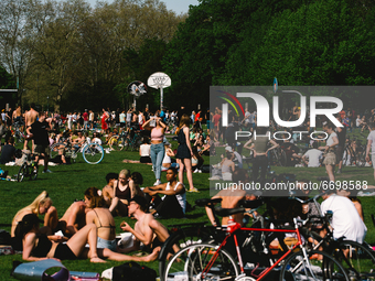 people relax and enjoy the warm weather in Innerer Gruenguertel park in Cologne, Germany on May 9, 2021 amid the coronavirus pandemic. (