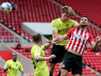   Bailey Wright of Sunderland contests a header with Northampton Town's Fraser Horsfall during the Sky Bet League 1 match between Sunderland...