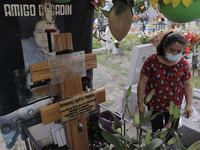 A woman visits the grave of her mother and son inside the San Francisco Culhuacan Town Cemetery in Mexico City on the eve of Mother's Day to...