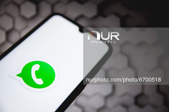 In this photo illustration a Whats App logo seen displayed on a smartphone screen with a computer wallpaper in the background in Athens, Gre...