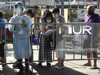 Thai People from the residential community queue up during a proactive mass nasal swab test to contain the rapid spreading of the COVID-19 p...
