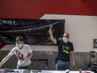 Workers standing at a booth for the June 4 Vigil in Hong Kong, Sunday, May 9, 2021. The Hong Kong Alliance in Support of Patriotic Democrati...