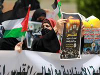 Palestinian protesters chant anti-Israel slogans during a demonstration in Gaza City, on May 10, 2021, in solidarity with fellow Palestinian...