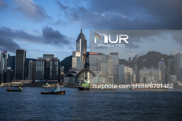 Ships carrying Cargo sail pass the Wan Chai City Skyline, Hong Kong Convention and Exhibition Centre in Hong Kong, Monday, May 10, 2021. 