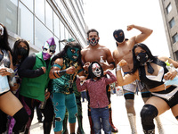 Mexican Wrestlers during the  'two of three falls' brigade of the Mexico City by  Youth Institute  promote the use of masks and other sanita...
