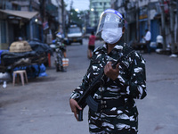 Security personnel stand guard during curfew due to rise of COVID-19 coronavirus cases, in Guwahati, India on 11 May 2021.  India recorded 3...