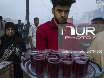 Traditional fruit juice donation to the people  in the Ramses train station area before the iftar , the first meal of the Ramadan day on Apr...