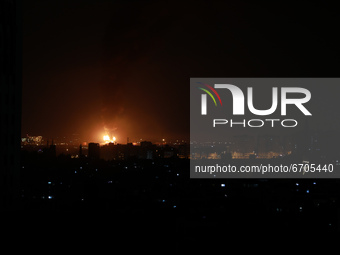 A huge column of smoke seen from Gaza city billows from an oil facility in the southern Israeli city of Ashkelon, on May 12, 2021, after roc...