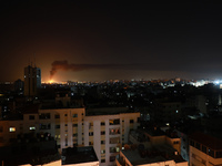 A huge column of smoke seen from Gaza city billows from an oil facility in the southern Israeli city of Ashkelon, on May 12, 2021, after roc...