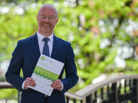 Stephen Donnelly, Ireland's Minister of Health, poses for a photo with a copy of the Healthy Ireland strategic action plan at Dublin Castle....