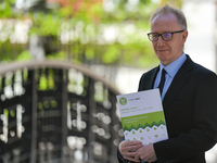 Frank Feighan, Minister of State for Public Health, Well Being and National Drugs Strategy, poses for a photo with a copy of the Healthy Ire...