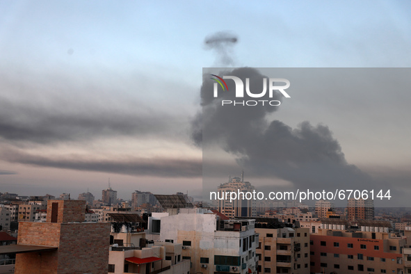 Smoke rises after an Israeli air strike in Gaza City near Barcelona Park and multiple government places, one of the biggest air strikes on t...