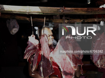 Butcher wait for customer at traditional market as muslims prepares for the Eid Al Fitr fest in the last day of the holy month Ramadhan, in...