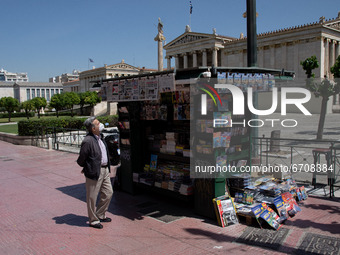 A man is looking at the newspapers at a kiosk at the center of Athens, Greece on May 12, 2021. (