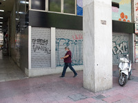 A man seen walking past a closed store at the center of Athens, Greece on May 12, 2021. (