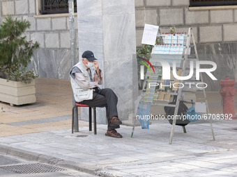 A man is selling lotteries at the center of Athens, Greece on May 12, 2021. (