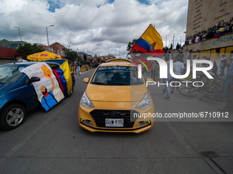 Taxi drivers wave flags as thousands flood Bogota, Colombia on may 12, 2021 to protest against the government of president Ivan Duque and th...