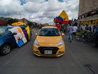 Taxi drivers wave flags as thousands flood Bogota, Colombia on may 12, 2021 to protest against the government of president Ivan Duque and th...