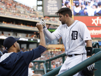 Detroit Tigers' Nick Castellanos is congratulated by pitcher David Price after scoring a run in the fourth inning of a baseball game against...