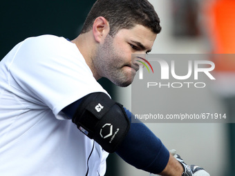 Detroit Tiger's Alex Avila warms up in the dugout having returned for his first game back after being on the disabled list of a baseball gam...