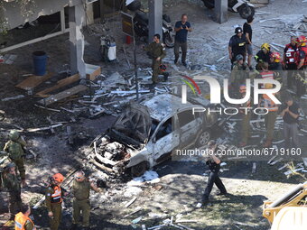 Police and rescue teams at the scene of a direct rocket hit, which was fired from the Gaza Strip, in Ramat Gan, causing the death of one Isr...