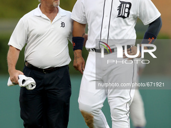 Detroit Tigers' Miguel Cabrera is assisted off the field by trainer Kevin Rand after suffering a left calf strain of a baseball game against...