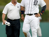 Detroit Tigers' Miguel Cabrera is assisted off the field by trainer Kevin Rand after suffering a left calf strain of a baseball game against...
