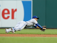 Toronto Bluejays second baseman Devon Travis leaps in a failed attempt to catch the ball hit by Detroit Tigers' Victor Martinez during the f...