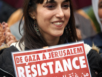 A young woman holds a placard reading 'From Gaza to Jerusalem: resistance'. Hundreds of people gathered in support of Gaza and the Occupied...