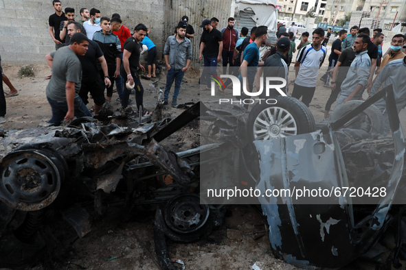 Palestinians inspect the wreckage of a car after it was hit by an Israeli missile strike in Gaza City Saturday, May 15, 2021.
 