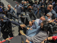 Protesters scuffle with the security forces during a demonstration held by thousands of Tunisian an Palestinian demonstrators on avenue Habi...