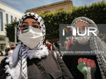Young women wearing the Palestinian keffiyeh pose for pictures in front of the French embassy as they attend a demonstration held by thousan...
