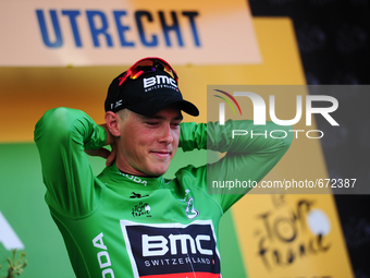 BMC Racing Team rider Rohan Dennis of Australia puts on the green jersey after winning Stage 1 of the Tour de France in Utrecht, Holland on...