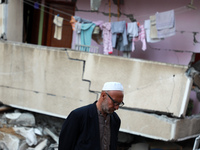 A Palestinian man walks past a destroyed building in a heavily-damaged residential neighbourhood of Gaza City early on May 16, 2021. (