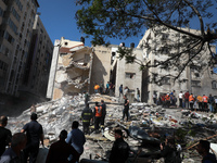 Palestinians inspect a destroyed house, after it was struck by Israeli strikes, in Gaza City, May 16, 2021. - Israeli forces pummeled the de...