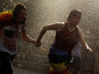 SPAIN, Madrid:People playing with water due to the heatwave in Spain during the 2015 gay pride parade in Madrid on July 4, 2015. ( 