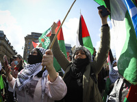 Demonstrators show their support for Palestine during a demonstration against state violence in George Square on May 16, 2021 in Glasgow, Sc...